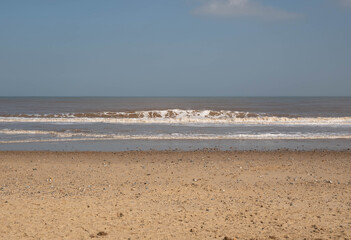 Fototapeta na wymiar Blue sky ,sand and sea at a North Norfolk sandy beach