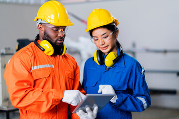 engineer cooperation male and female technician maintenance control relay robot arm system welding...