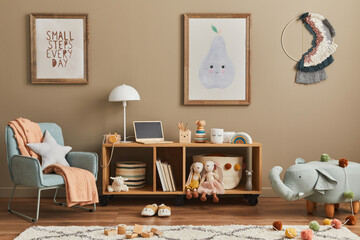 Stylish scandinavian kid room interior with toys, teddy bear, plush animal toys, mint armchair, furniture, decoration and child accessories. Brown wooden mock up poster frames on the wall. Template