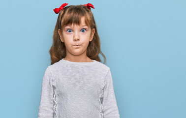 Little caucasian girl kid wearing casual clothes making fish face with lips, crazy and comical gesture. funny expression.