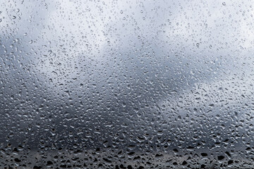 Water drops on window glass, closeup. Rainy weather
