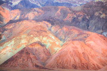 Pastel colour and abstract texture of the otherworldly colourful volcanic rock terrain of the badlands landscape in Death Valley Park National Park, USA.