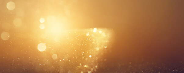 background of abstract gold and black glitter lights. defocused