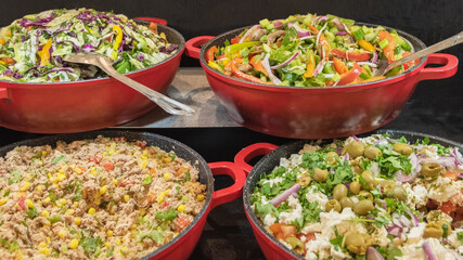 The regional cuisine of Israel in a hotel. Different types of fresh vegetable salads. Buffet etiquette