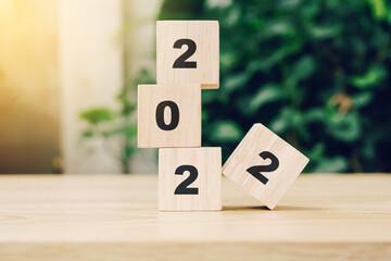 2022 happy new year on wood block on wood table with sunlight. new year concept.