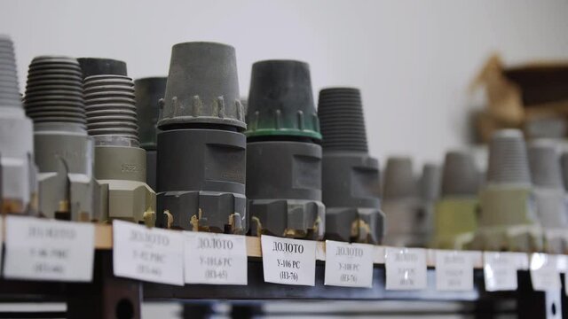 Drill Bits on shelving in stock. Oil drilling equipment for drilling rig operation on oil platform in oil and gas industry. Brand new PDC Polycrystalline Diamond Compact drilling bit