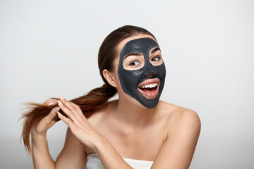 Beauty portrait woman skin care health black mask white background close up.  Cosmetic mask .  Spa treatment . Cosmetology