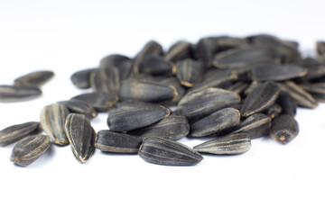 Fried black sunflowers seeds, close up.