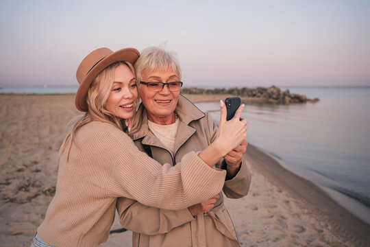 Adult Daughter And Her Elderly Mother Make Selfie On The Beach