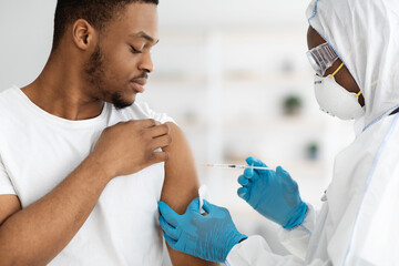 Closeup of african american man receiving vaccine shot - obrazy, fototapety, plakaty
