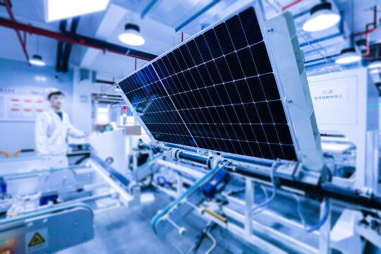 Factory workers lifting new solar panel from production line,and  the technician is checking it in the factory.Intelligent industrial background image.