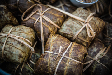 Steamed rice wrapped in lotus leaves for sale at Walking Street Market, Naklua, Pattaya, Thailand