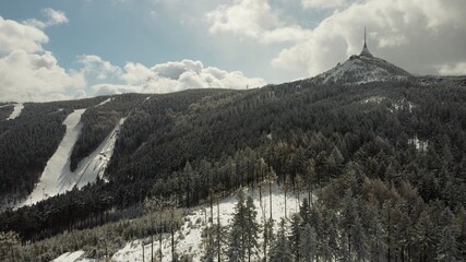 Winter drone photo of Ještěd.
Snow covered trees.