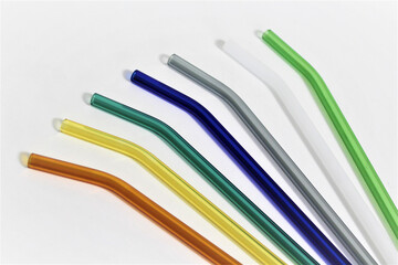 Colorful reusable glass straws on white background. An alternative replacement for classic disposable plastic drinking straw, great  for the environment, Eco-friendly, Sustainability