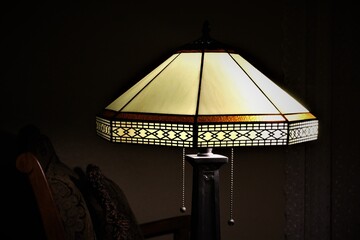 Detailed Vintage style night lamp in a dark room. Tiffany glass. Stone Filigree. Close up shot