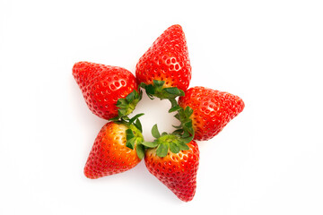 Top view on a fresh strawberry berries arranged in circle on white background. Fresh organic fruit, healthy clean eating concept. Food blog, spring fruits background.