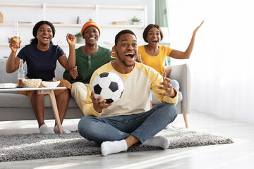 Emotional african american friends watching football game at home © Prostock-studio