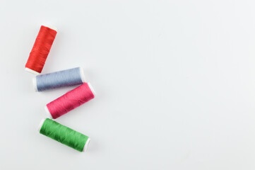 Bunch of colorful threads over white background with copy space