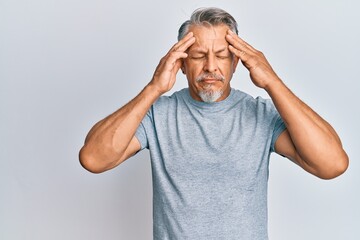 Middle age grey-haired man wearing casual clothes with hand on head, headache because stress. suffering migraine.