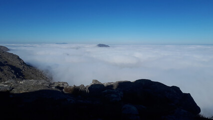 Fototapeta na wymiar With the clouds lower than the summit it is like a magic carpet ride