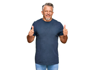 Middle age grey-haired man wearing casual clothes success sign doing positive gesture with hand, thumbs up smiling and happy. cheerful expression and winner gesture.