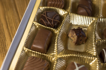 Bitten chocolate candy in a box
