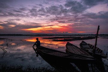 An afternoon beside a vast wetland surrounded by farmlands, with partly cloudy evening blue sky 