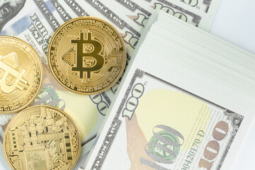 Bitcoins coin and  US banknotes of one hundred dollars