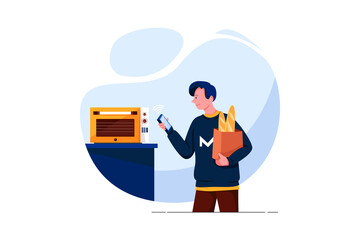 Happy young man looking at oven with voice recognition function in kitchen