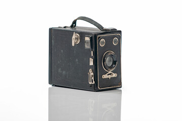 Vintage camera isolated on a white background with reflection