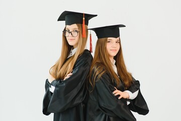 Pretty female college graduate at graduation with classmates