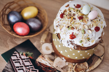 Easter cake decorated nuts dried fruits with colorful eggs on the wood stand