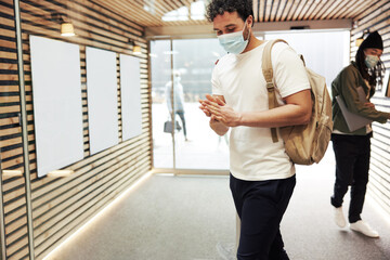 Diverse young businesspeople sanitizing their hands at work