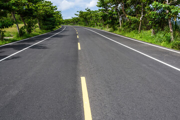 Asphalt road with blue sky in the countryside of Pingtung, Taiwan.