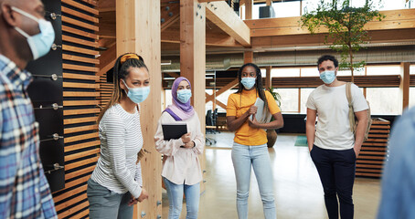 Diverse businesspeople wearing face masks in an office