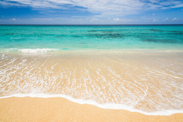 Ocean waves, beach, and blue sky in Taitung, Taiwan.
