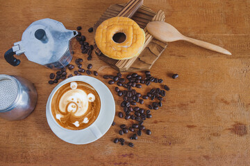 Hot cappuccino art with fresh coffee bean on table.