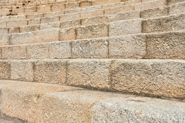 Stones make up the stairs and public seating in the ruins of a Roman theater