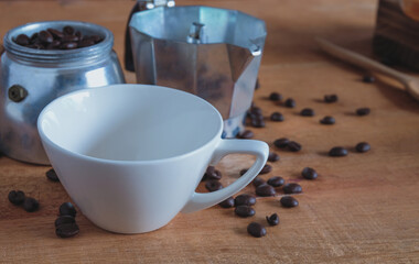 Coffee maker home made with empty white mug on wood table.
