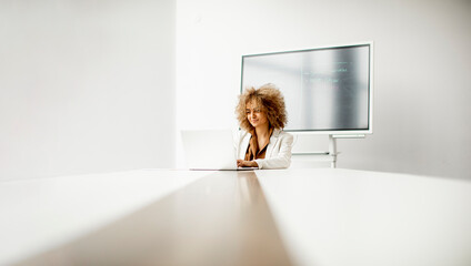 African American businesswoman sitting and working on laptop in the modern office