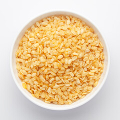 Close-Up of Crunchy Moong Dal in a white Ceramic bowl, made with roasted Mung bean. Indian spicy snacks (Namkeen), Top View