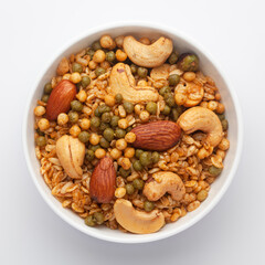 Close-Up of Shahi Mixture in a white ceramic bowl, made with peanut, cashew, almonds. Indian spicy snacks (Namkeen). Top View