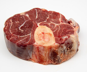A piece of raw meat with a bone on a white background.