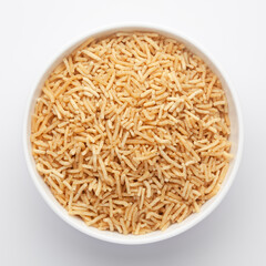 Close-Up of Salty plane Bhujia in a white ceramic bowl, made with Chickpeas or gram flour (Besan).  Indian salty snacks (Namkeen), Top View