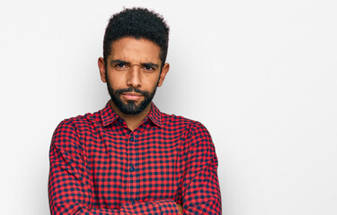 Young african american man wearing casual clothes skeptic and nervous, disapproving expression on face with crossed arms. negative person.