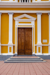 entrance to the yellow house in Nicaragua with wooden door