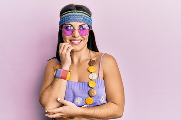 Young brunette woman wearing bohemian and hippie style looking stressed and nervous with hands on mouth biting nails. anxiety problem.