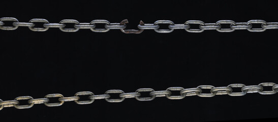 broken link metal chain isolated on black background