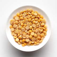 Macro Close-up of Organic arhar dal (Cajanus cajan) or split yellow dal inside a ceramic white bowl. Top view 