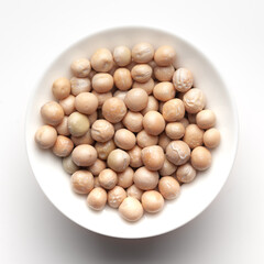 Macro Close up of Close up of Organic dry peas whole (Pisum sativum) or matar dal inside a ceramic white bowl. Top view 